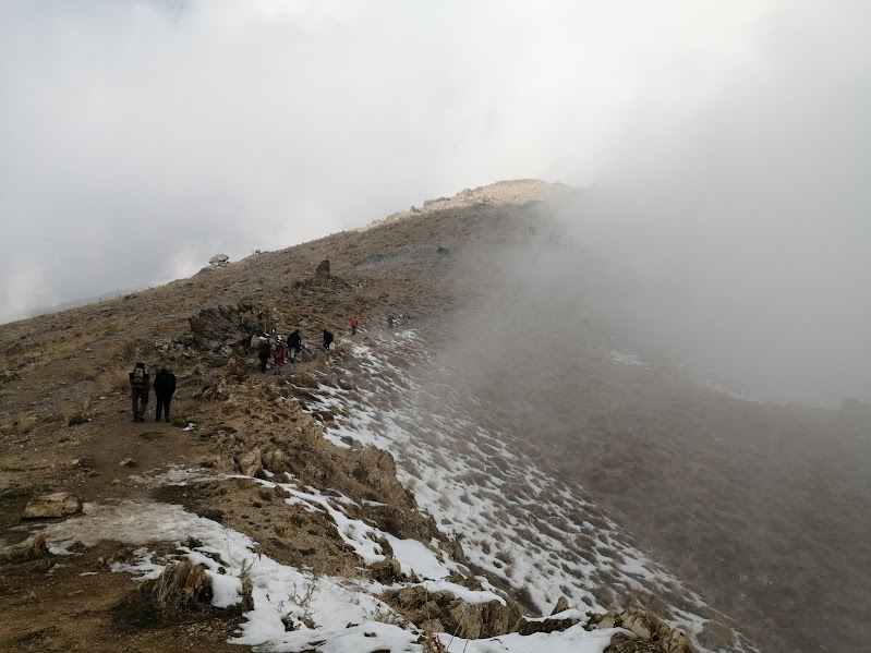Hikers on a misty mountain trail