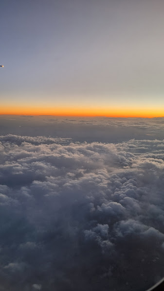 Sunset view above the clouds from an airplane