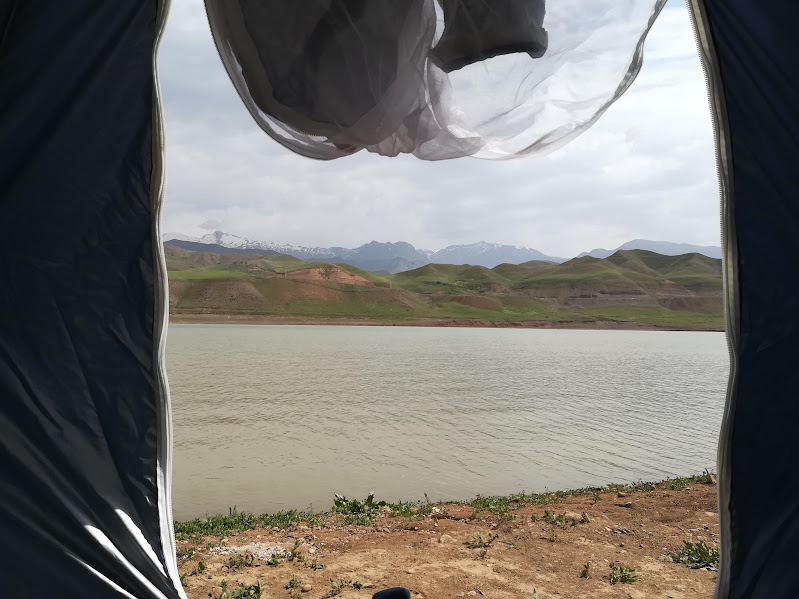 View of a lake from inside a tent